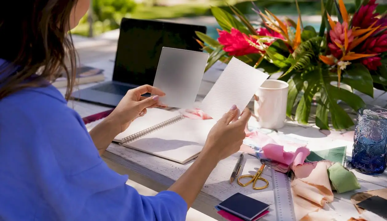 Designer comparing wedding bar menu sign materials samples