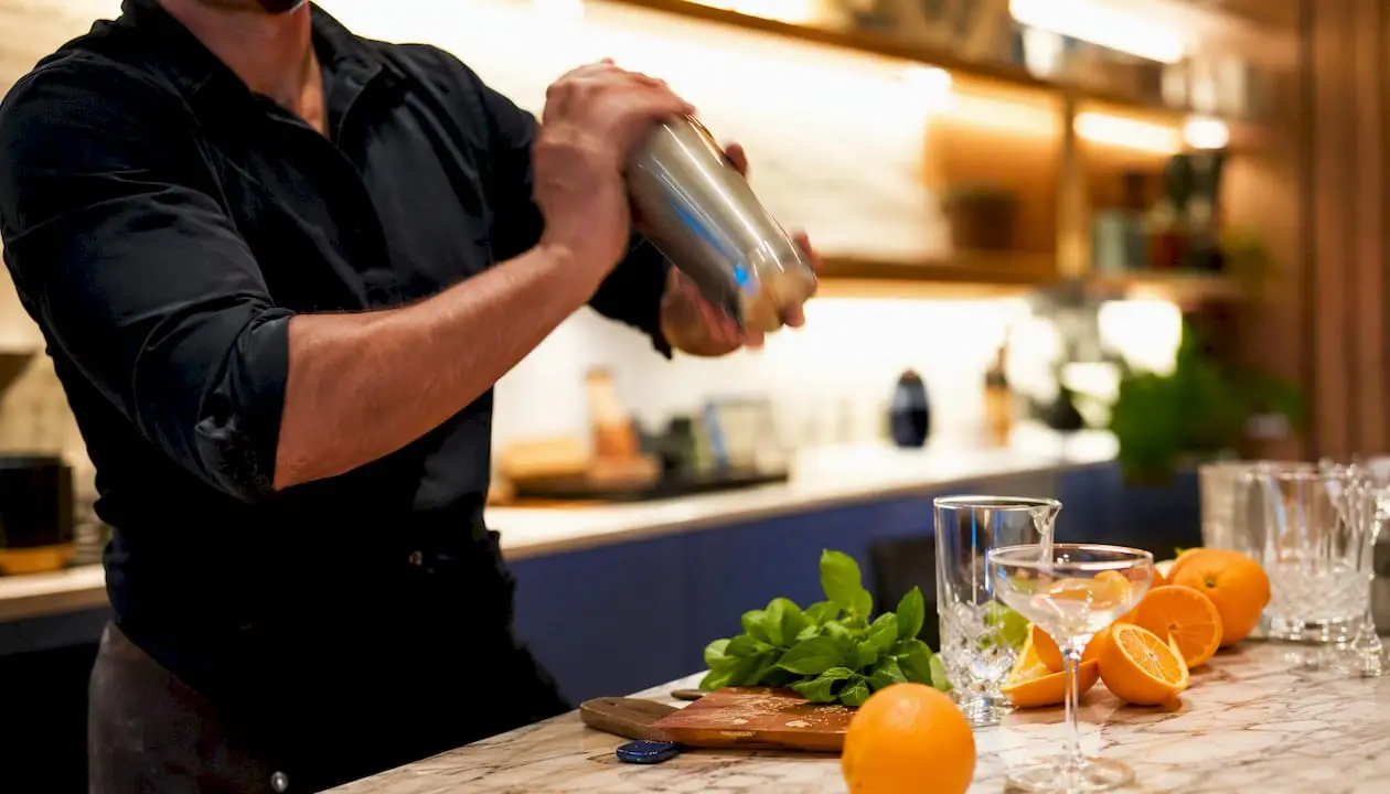 Bartender shaking cocktail in private class