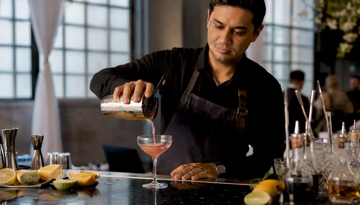 Bartender pouring cocktail at corporate event bar