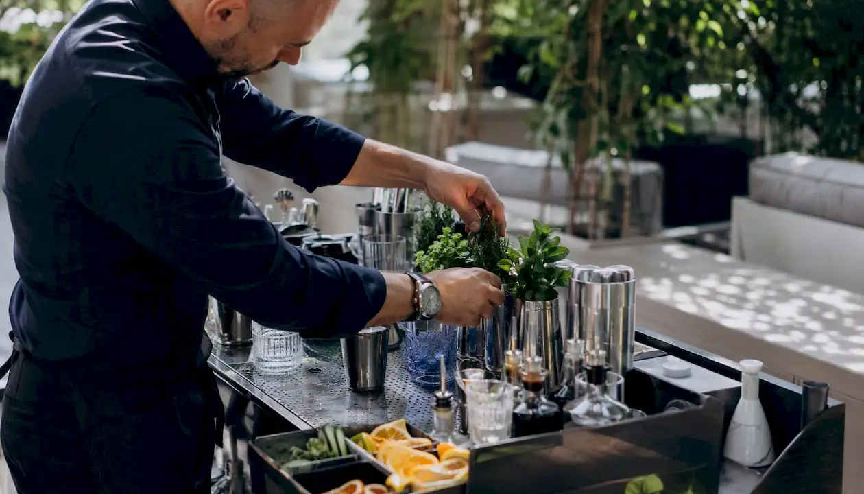 Bartender arranging garnishes on event bar
