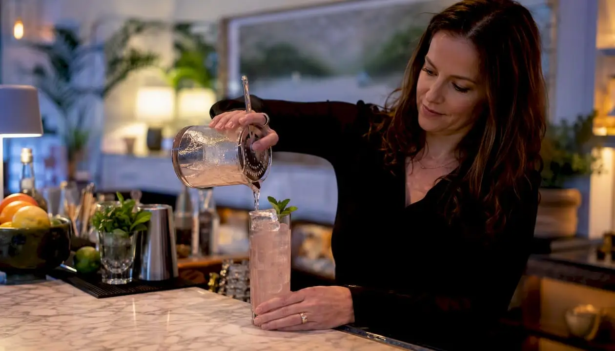 Bartender pouring floral elderflower spritz mocktail