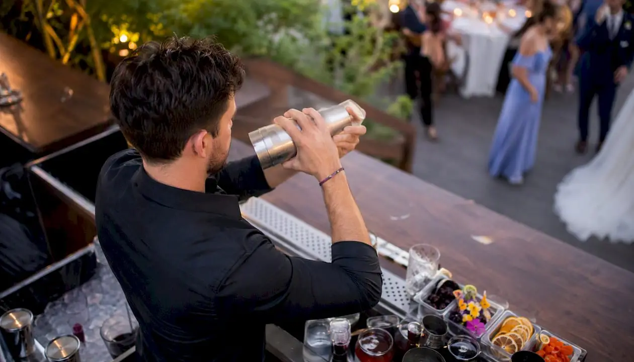 Bartender pouring signature wedding cocktail