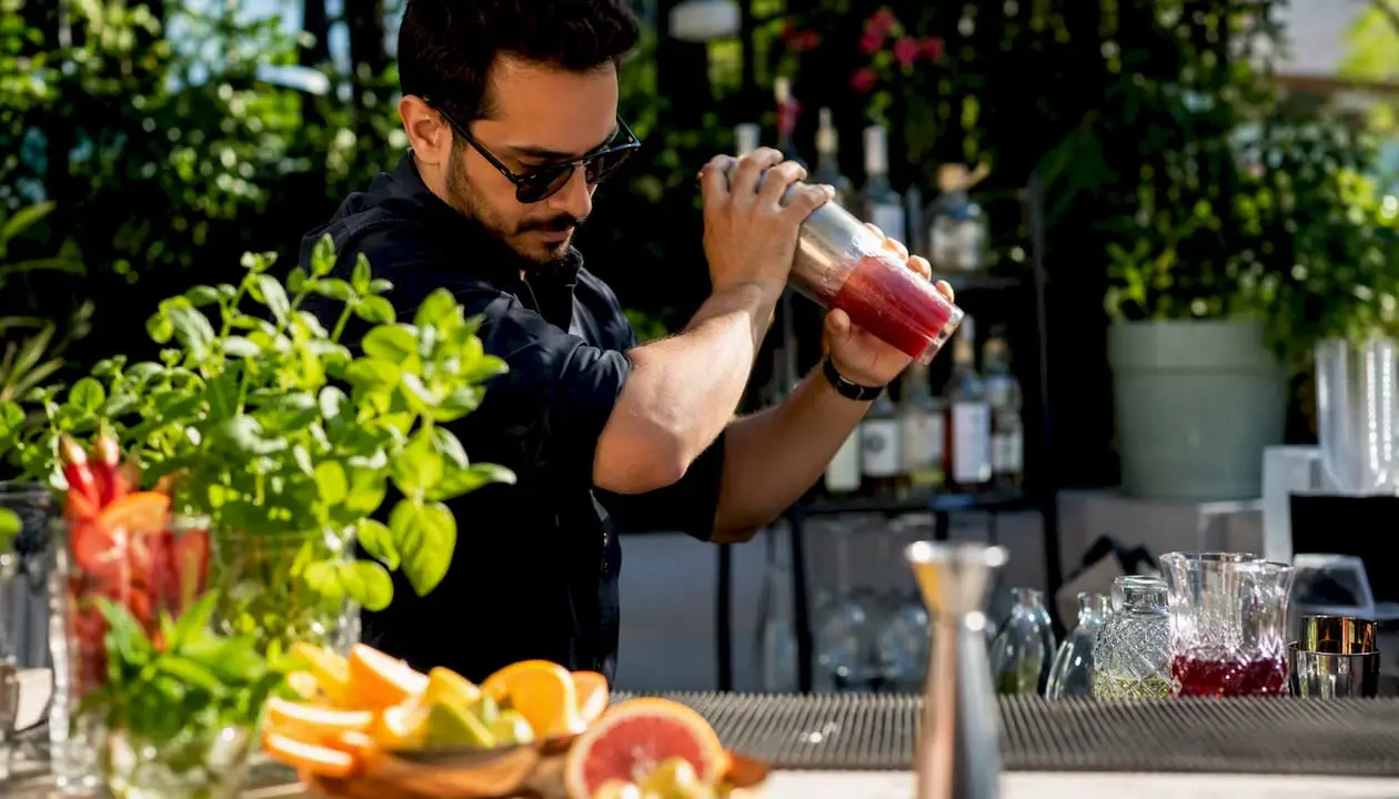 Bartender pouring a cocktail during class