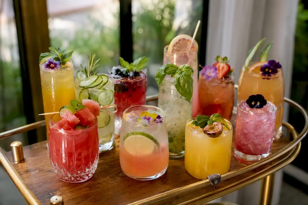 Assorted colorful vegan mocktails with fresh garnishes