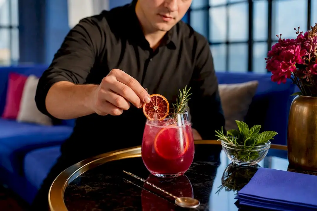 Bartender garnishing an elevated wedding mocktail